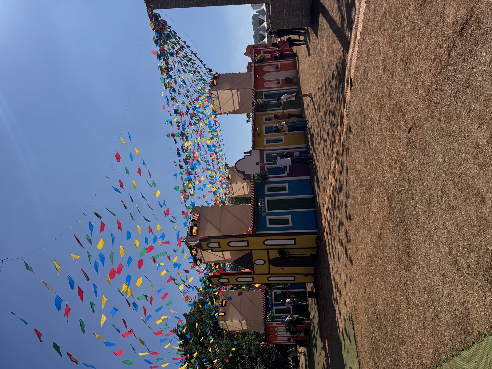 Bunte Wimpelketten und Holzhütten bei einer Festa Junina